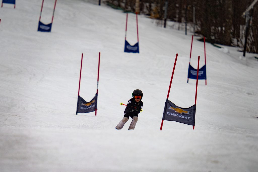 person ski racing between gates