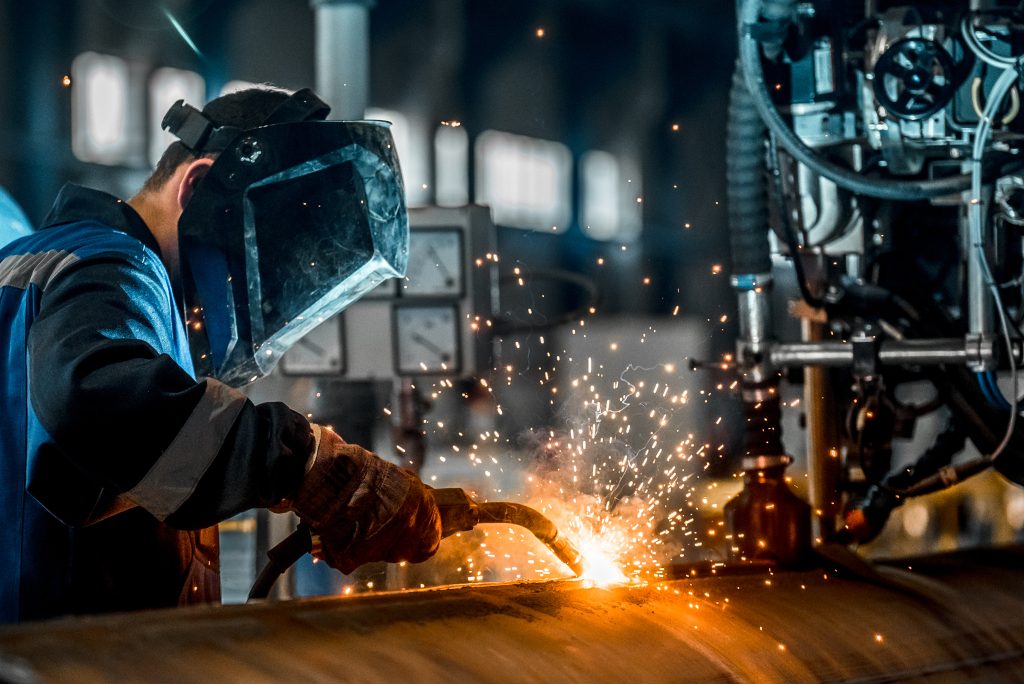 man welding in a factory 