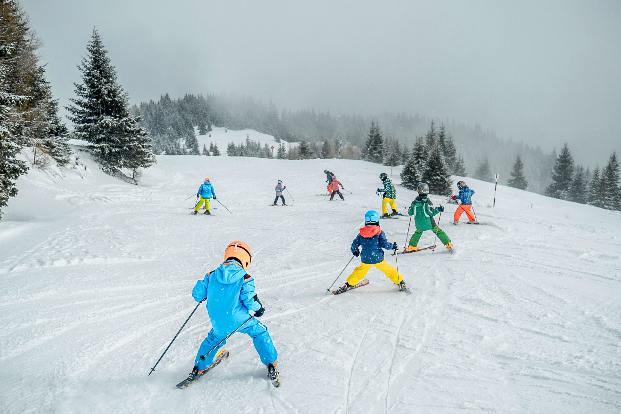 Ski lesson for kids on a snowy peak